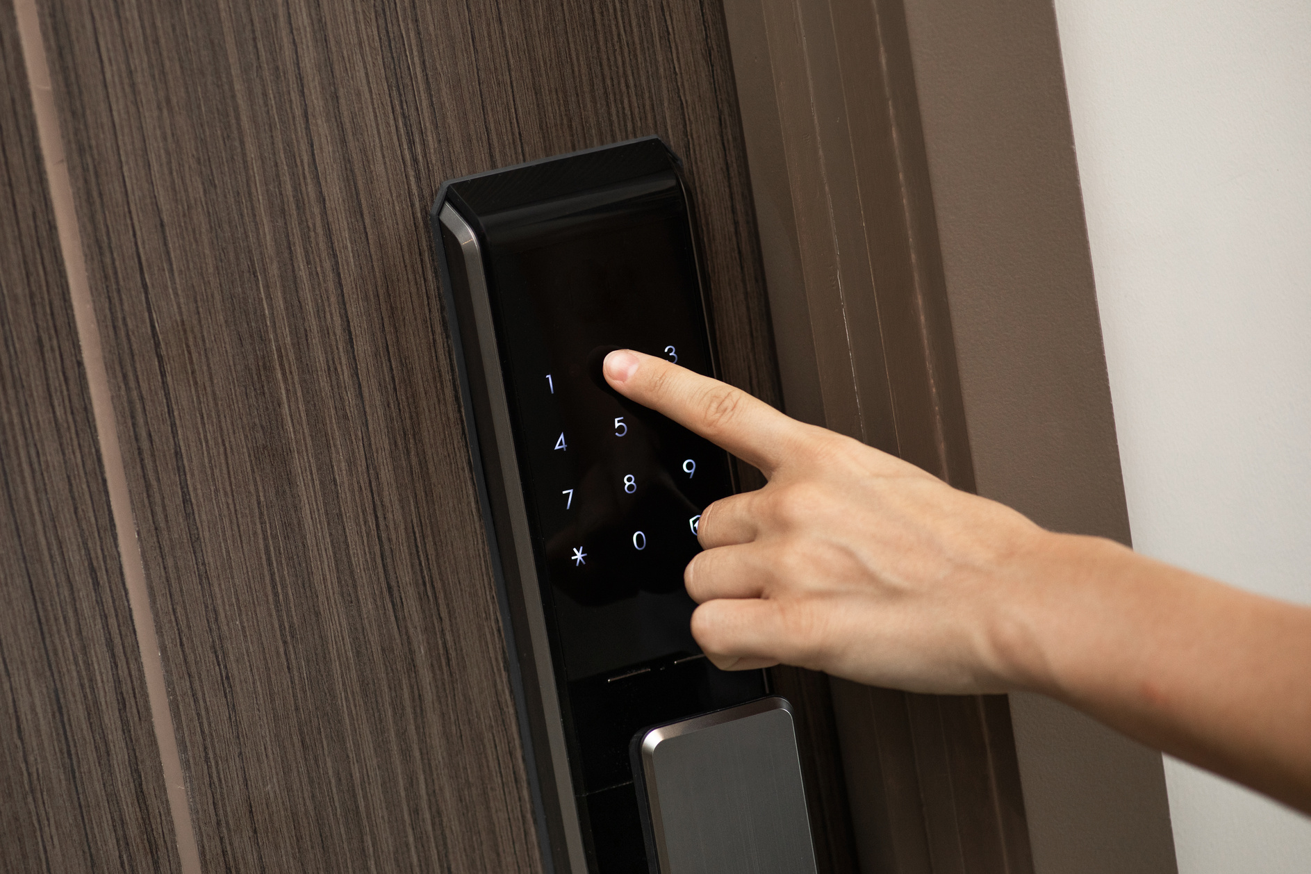 Hand and Digital Smart Code Lock into the Modern Apartment